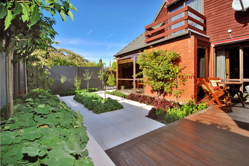 Mid-sized contemporary backyard deck in Christchurch with no cover.