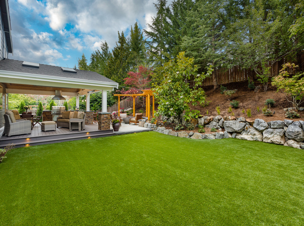 Design ideas for a large arts and crafts backyard full sun garden in Seattle with a retaining wall and decking.