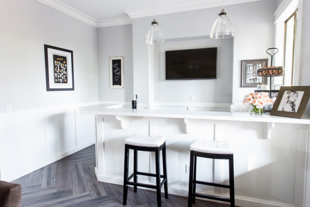 Inspiration for a modern single-wall wet bar in Phoenix with a drop-in sink, raised-panel cabinets, white cabinets, quartzite benchtops, white splashback, subway tile splashback and ceramic floors.