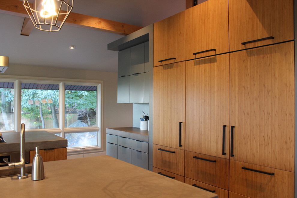 Design ideas for a mid-sized contemporary galley open plan kitchen in Orange County with an undermount sink, flat-panel cabinets, medium wood cabinets, solid surface benchtops, stainless steel appliances, porcelain floors and multiple islands.