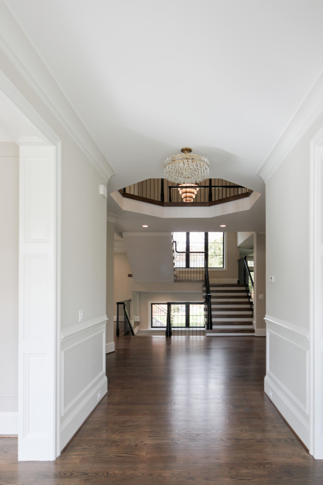 Expansive eclectic wood u-shaped staircase in DC Metro with wood risers and mixed railing.