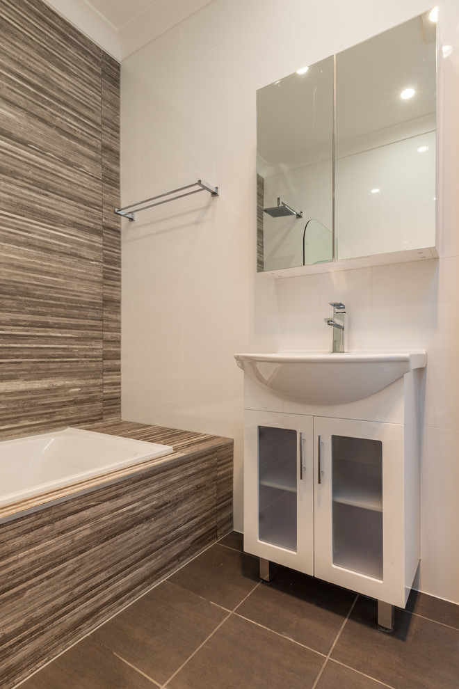 Design ideas for a small contemporary master bathroom in Sydney with furniture-like cabinets, white cabinets, a corner tub, a shower/bathtub combo, a two-piece toilet, brown tile, slate, white walls, ceramic floors, an integrated sink, brown floor and an open shower.