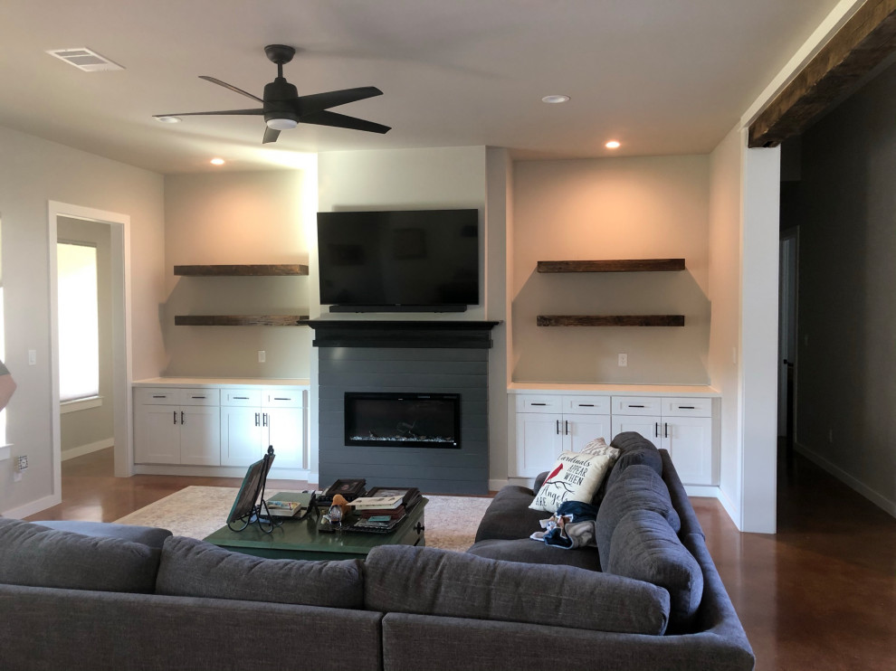 Photo of a contemporary family room in Austin with a standard fireplace and a wall-mounted tv.
