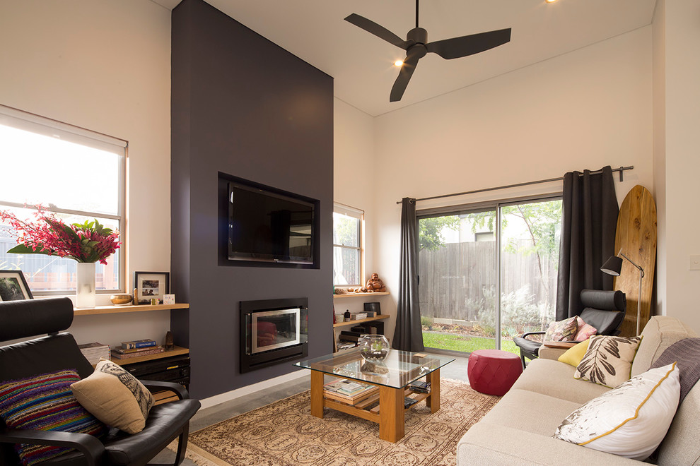 This is an example of a small eclectic open concept living room in Perth with white walls, concrete floors, a metal fireplace surround, a built-in media wall and a ribbon fireplace.