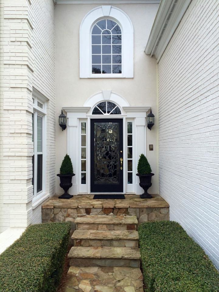Example of a large transitional front door design in Atlanta with a black front door