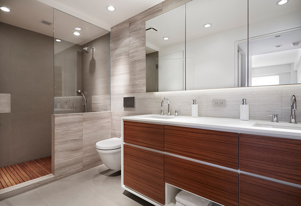 Large modern master bathroom in New York with an undermount sink, medium wood cabinets, an alcove shower, a wall-mount toilet and grey walls.