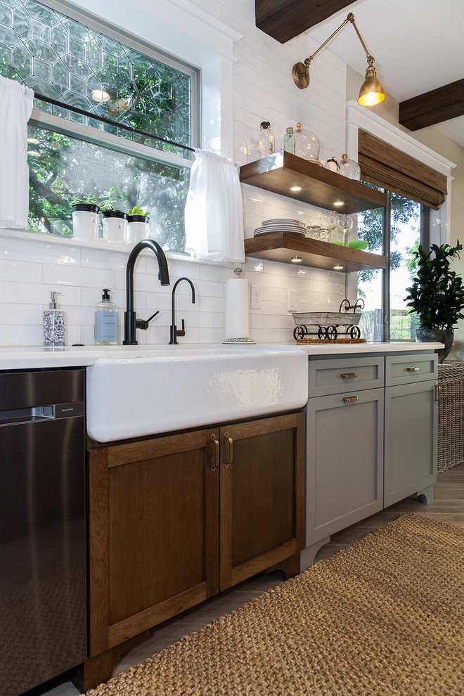 Inspiration for a large transitional l-shaped porcelain tile and brown floor eat-in kitchen remodel in Phoenix with a farmhouse sink, shaker cabinets, gray cabinets, quartz countertops, white backsplash, glass sheet backsplash, stainless steel appliances, an island and white countertops