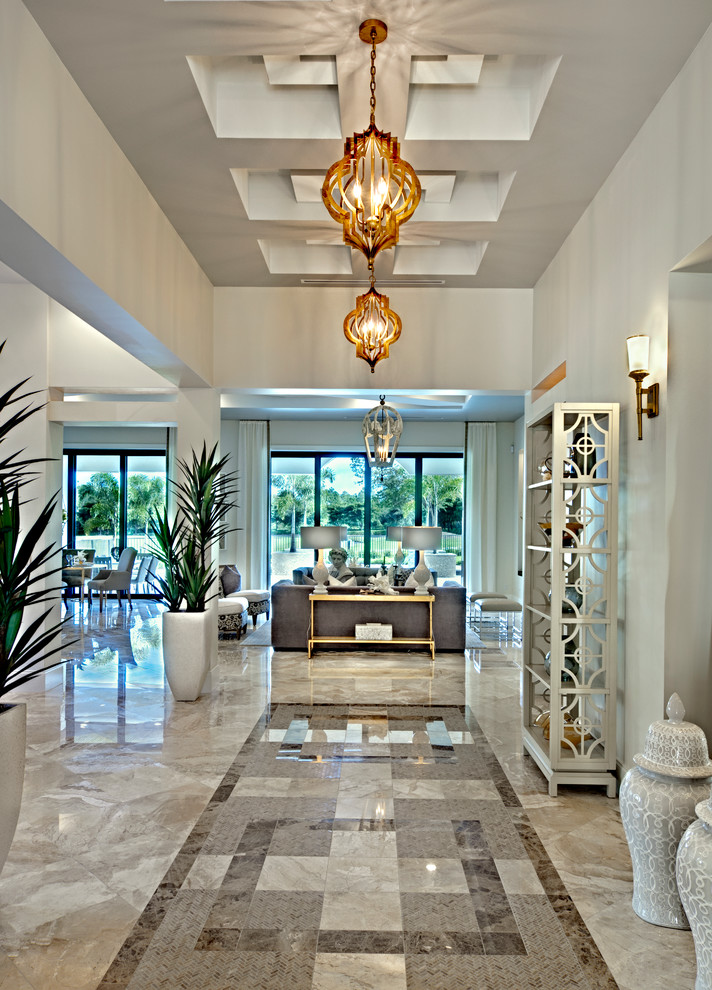 Large mediterranean foyer in Miami with beige walls, marble floors and a single front door.