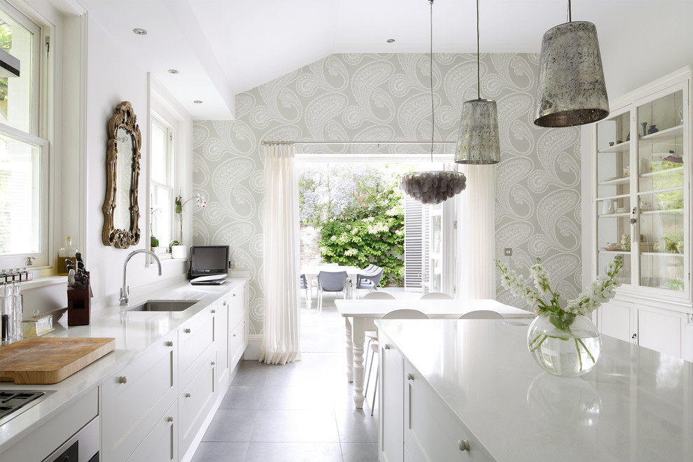 Contemporary eat-in kitchen in London with an undermount sink, glass-front cabinets, white cabinets and with island.