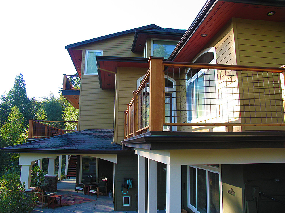 Design ideas for a large arts and crafts three-storey brown exterior in Seattle with wood siding and a gable roof.