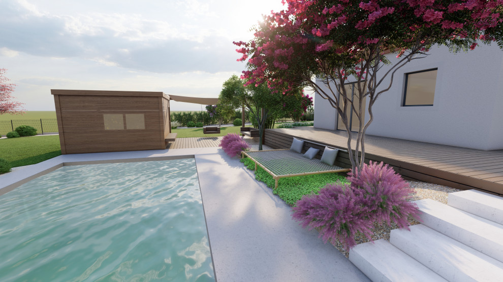 Modelo de piscina asiática grande rectangular en patio trasero con paisajismo de piscina y losas de hormigón