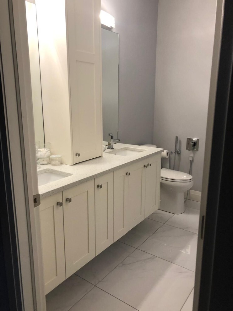Design ideas for a mid-sized transitional 3/4 bathroom in Toronto with a two-piece toilet, grey walls, an undermount sink, white floor, a drop-in tub, a corner shower, a hinged shower door, shaker cabinets, white cabinets, white tile, ceramic tile and turquoise benchtops.