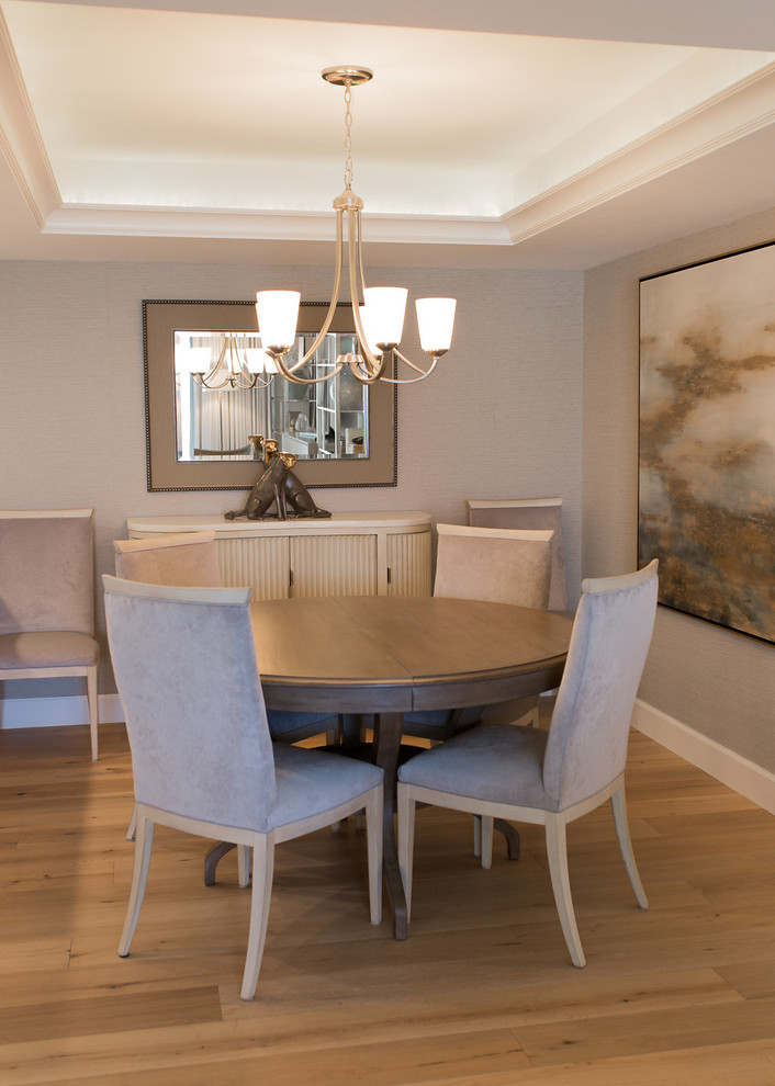 Example of a small transitional medium tone wood floor and brown floor dining room design in Miami
