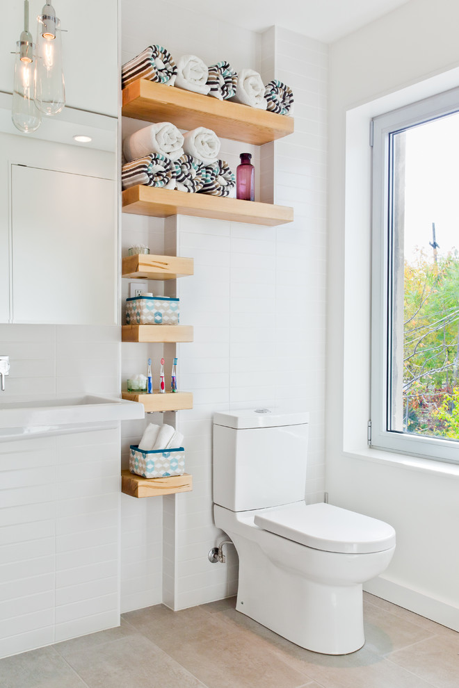 This is an example of a small contemporary bathroom in Toronto with open cabinets, a two-piece toilet, white tile and subway tile.