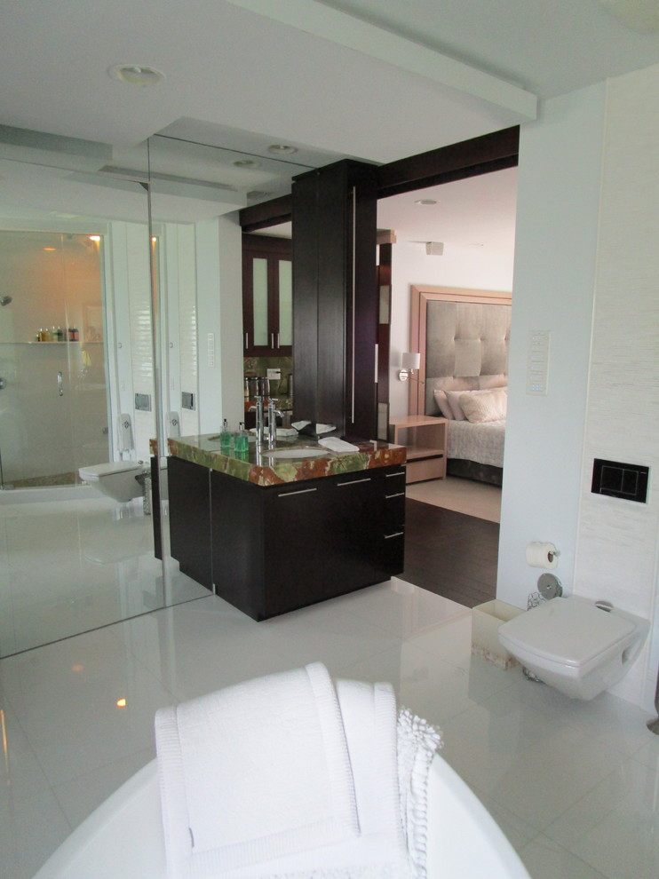 Freestanding bathtub - mid-sized eclectic master white tile and ceramic tile marble floor and white floor freestanding bathtub idea in Miami with furniture-like cabinets, dark wood cabinets, marble countertops, a hinged shower door, multicolored countertops, a one-piece toilet, white walls and an undermount sink