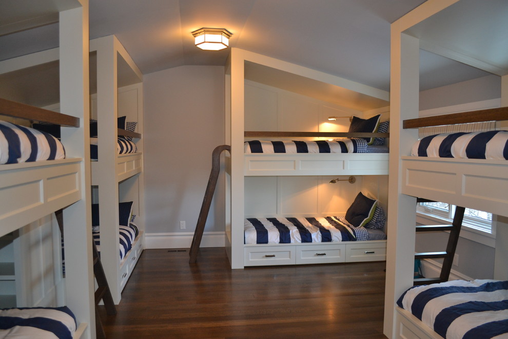 Photo of a large traditional gender-neutral kids' bedroom for kids 4-10 years old in Calgary with grey walls, medium hardwood floors and brown floor.