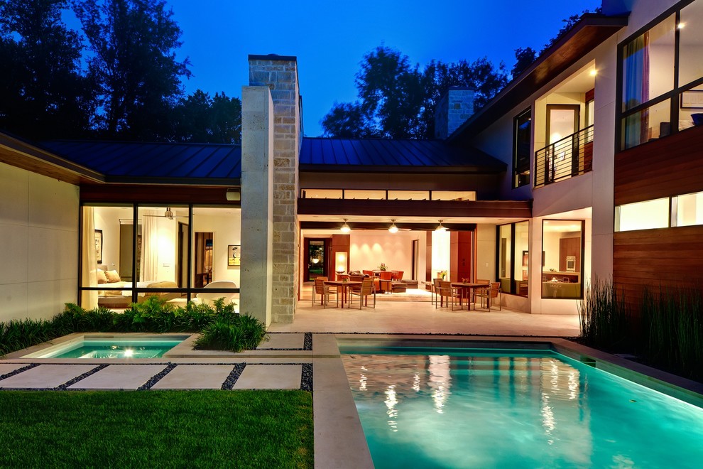 This is an example of a contemporary courtyard pool in Dallas.
