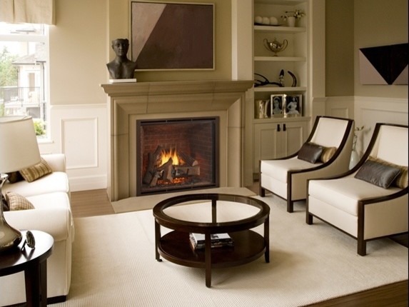Photo of a traditional living room in Minneapolis with beige walls, dark hardwood floors, a standard fireplace and no tv.