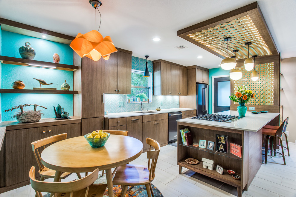 Photo of a midcentury galley kitchen in Dallas with an undermount sink, flat-panel cabinets, dark wood cabinets, blue splashback, black appliances, a peninsula, beige floor and white benchtop.