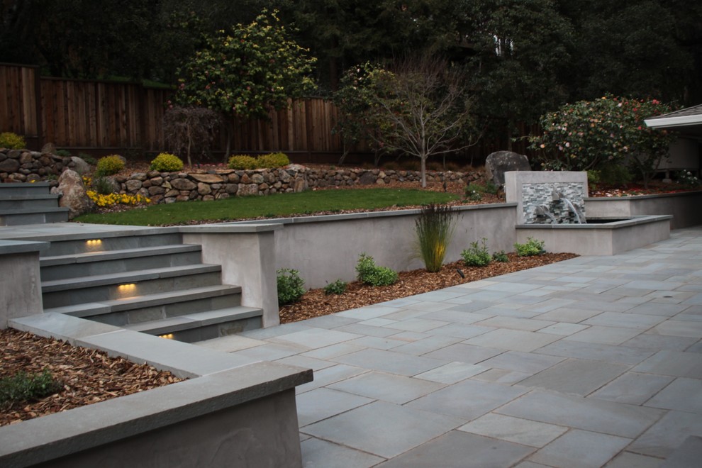 Large contemporary backyard patio in San Francisco with no cover and natural stone pavers.