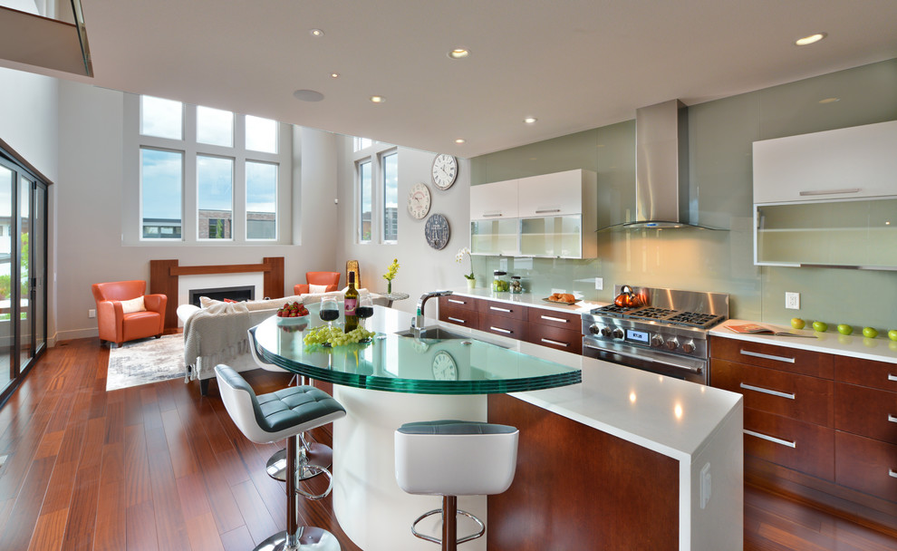 Inspiration for a mid-sized modern l-shaped eat-in kitchen in Vancouver with flat-panel cabinets, yellow cabinets, green splashback, stainless steel appliances, light hardwood floors and with island.