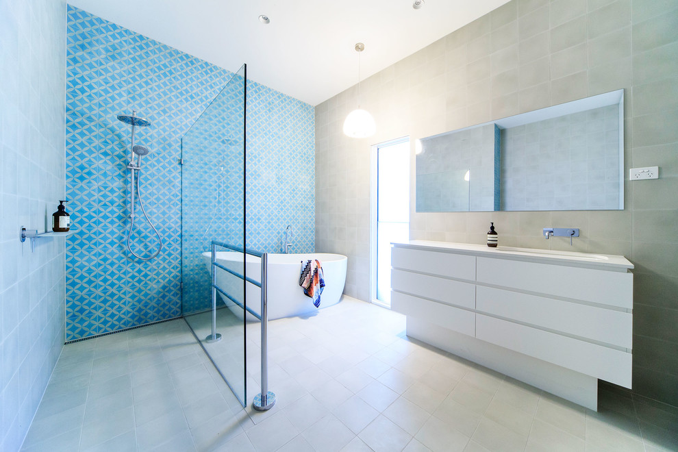 Inspiration for a mid-sized contemporary master bathroom in Melbourne with flat-panel cabinets, white cabinets, a freestanding tub, a corner shower, white tile, porcelain tile, white walls, ceramic floors, an undermount sink, granite benchtops and an open shower.