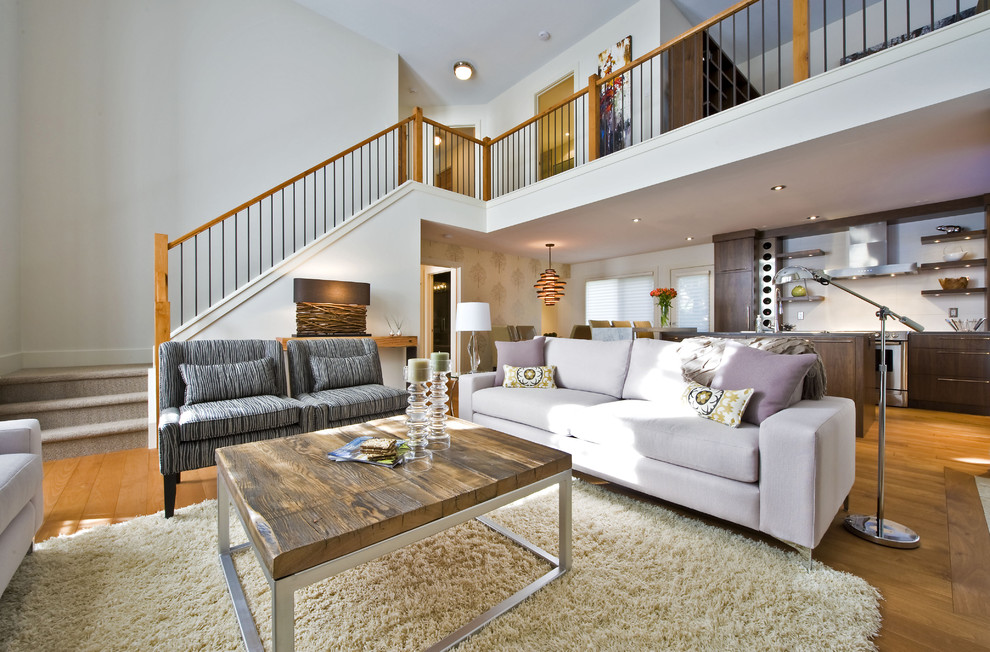 This is an example of a large contemporary open concept living room in Calgary with white walls.