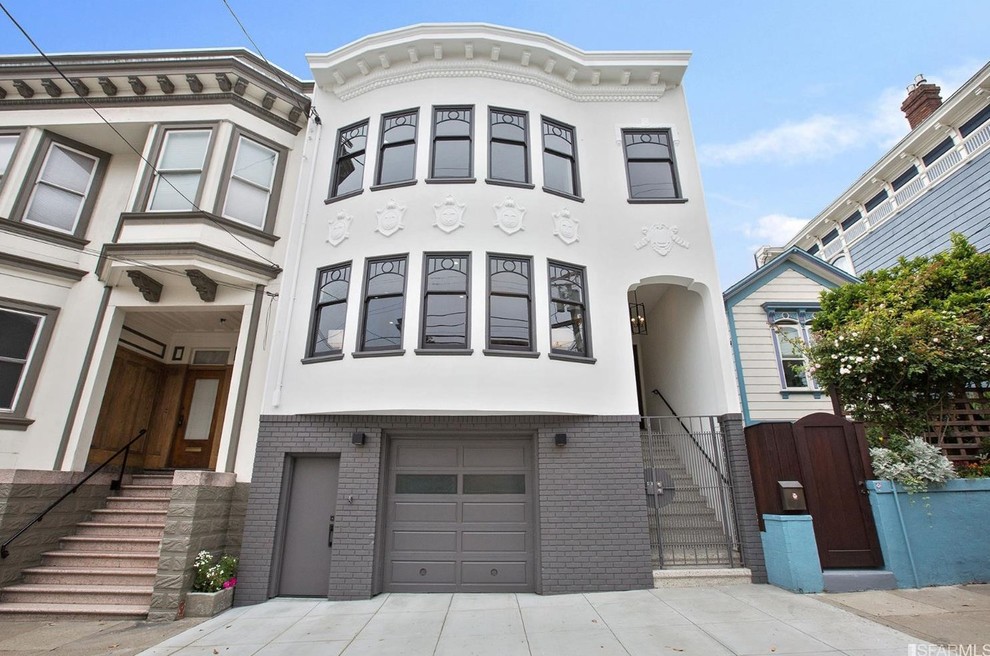 Photo of an expansive contemporary three-storey grey apartment exterior in San Francisco with mixed siding and a flat roof.