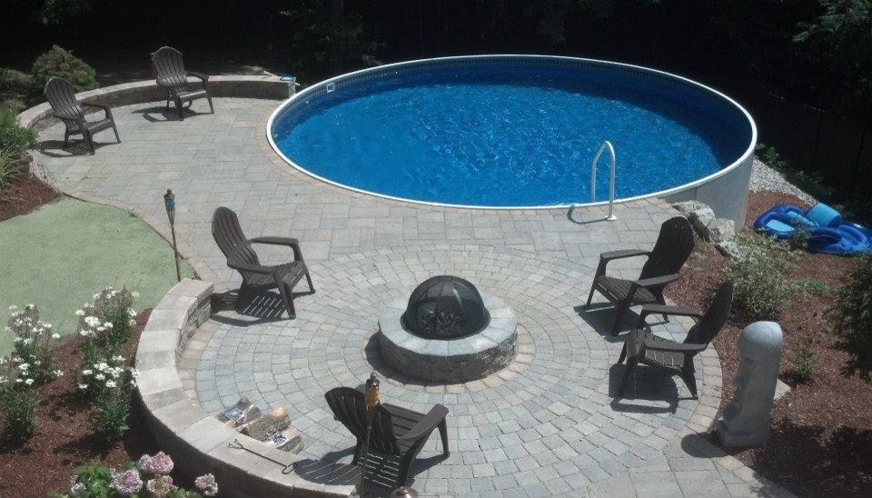 Design ideas for a small modern round infinity pool in Manchester with concrete pavers.
