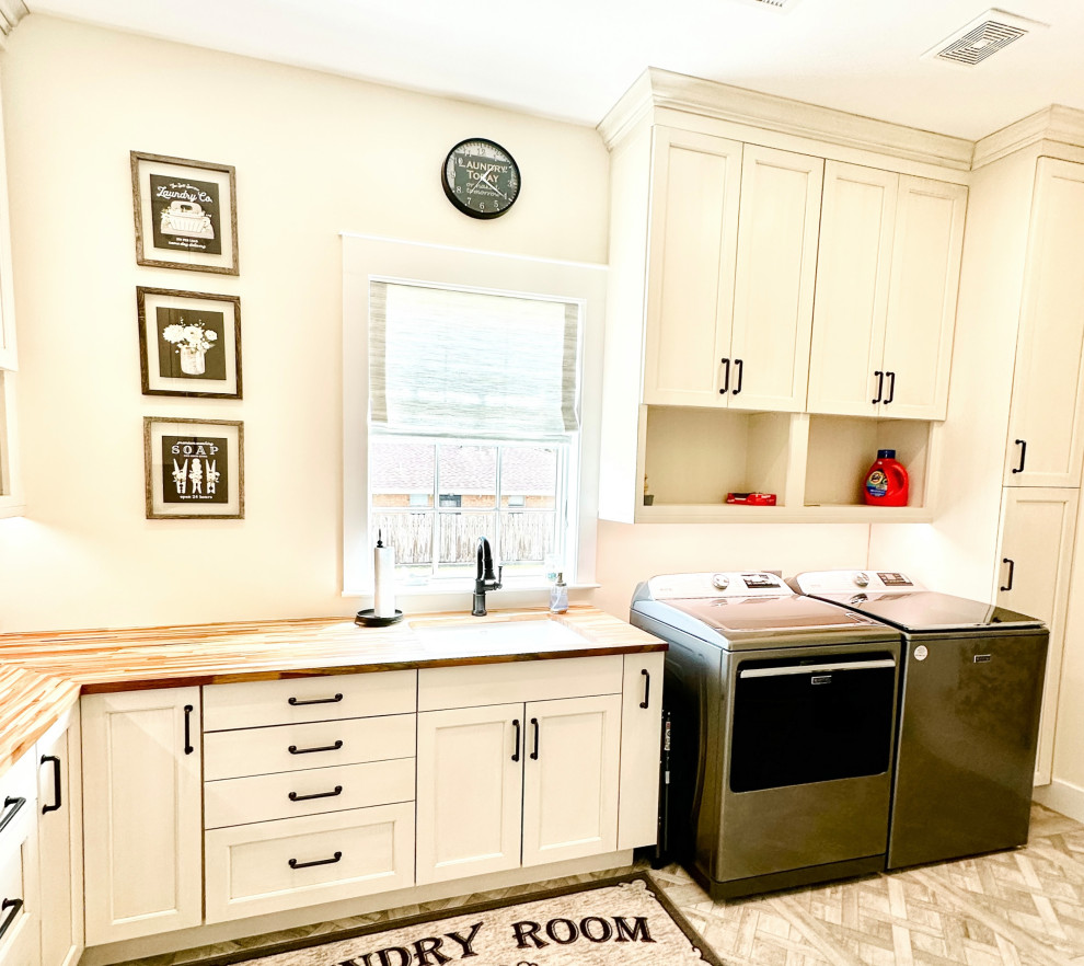 Photo of a large coastal l-shaped separated utility room in Houston with a submerged sink, shaker cabinets, white cabinets, wood worktops, white walls, porcelain flooring, grey floors and multicoloured worktops.