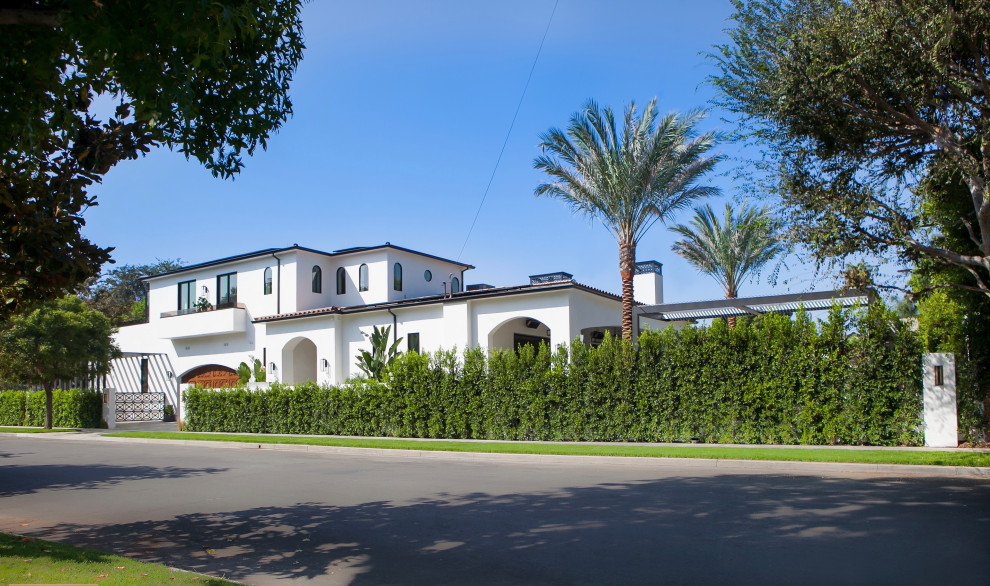 ロサンゼルスにある高級な地中海スタイルのおしゃれな家の外観 (漆喰サイディング、ウッドシングル張り) の写真