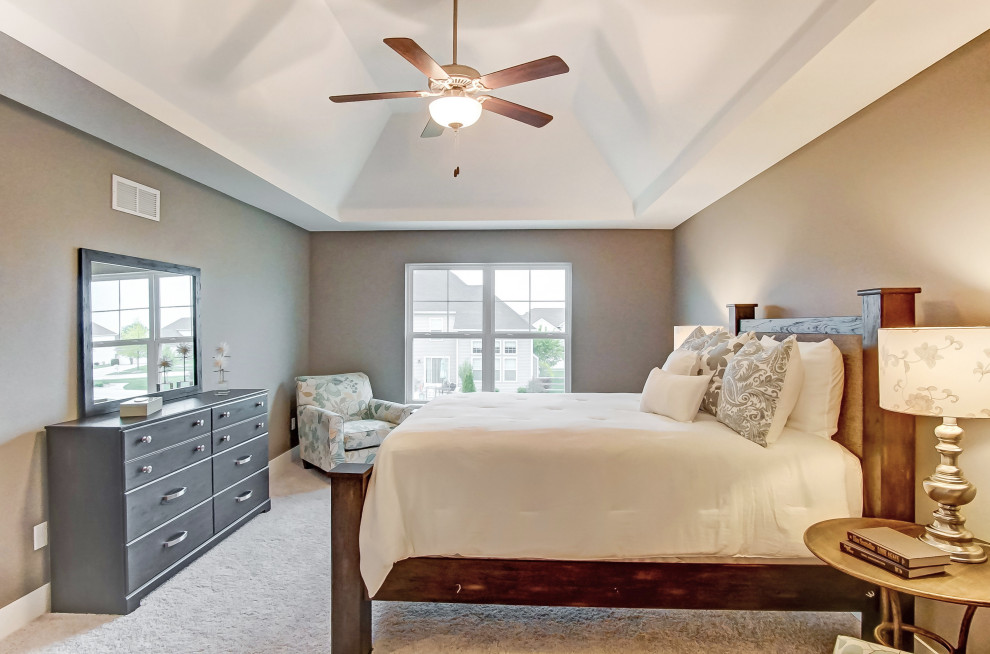 Large transitional master bedroom in Other with brown walls, carpet, no fireplace and grey floor.