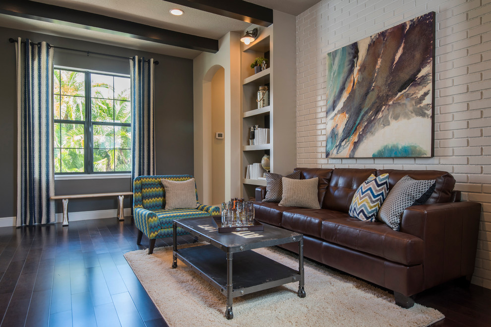 Par Street Model Loft - This stylish bonus loft features an authentic brick sofa backdrop, flanking built-in floor to ceiling bookshelves (both painted in a creamy white) contrasting beautifully with the ebony floors & stained ceiling beams.