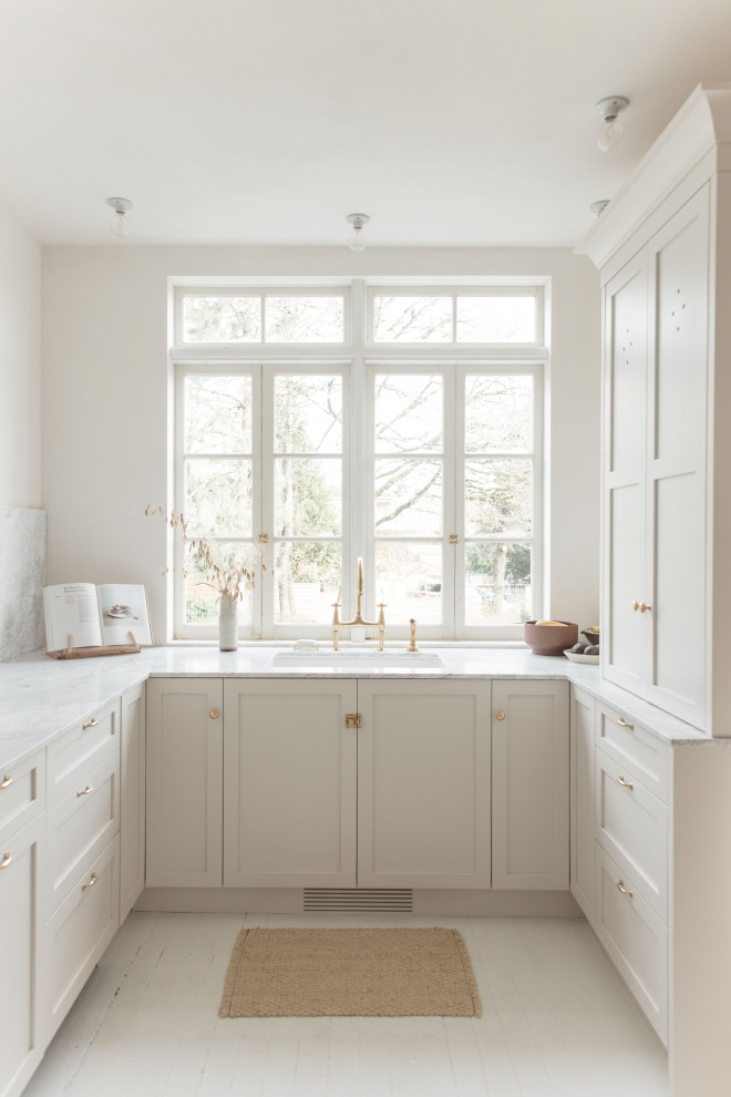 Inspiration for a small french country u-shaped painted wood floor kitchen remodel in Vancouver with a farmhouse sink, shaker cabinets, white cabinets, white backsplash, quartz backsplash, no island, white countertops, quartz countertops and paneled appliances