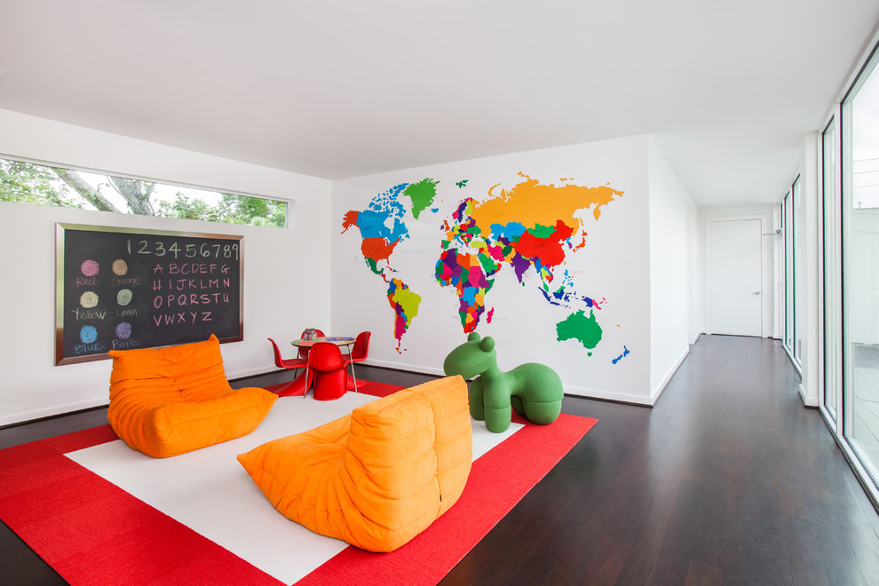 This is an example of a large contemporary gender-neutral kids' study room for kids 4-10 years old in Houston with white walls and dark hardwood floors.