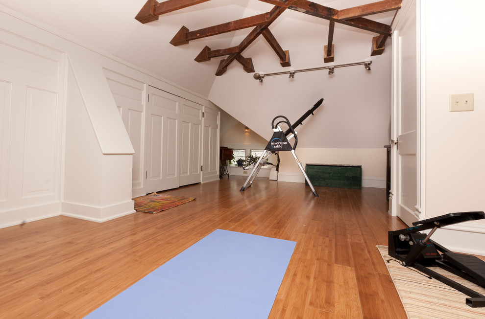 This is an example of a mid-sized eclectic multipurpose gym in Richmond with white walls and medium hardwood floors.