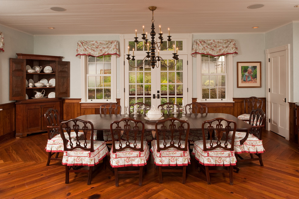 Country dining room in Raleigh with blue walls and dark hardwood floors.