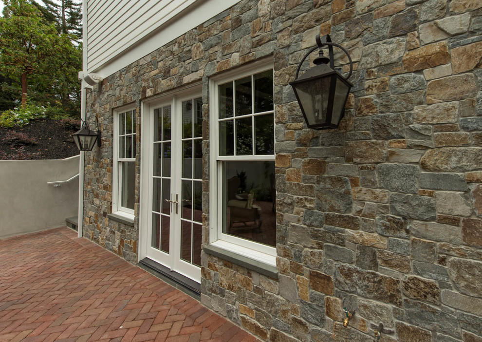 This is an example of a small traditional two-storey beige exterior in San Francisco with stone veneer.