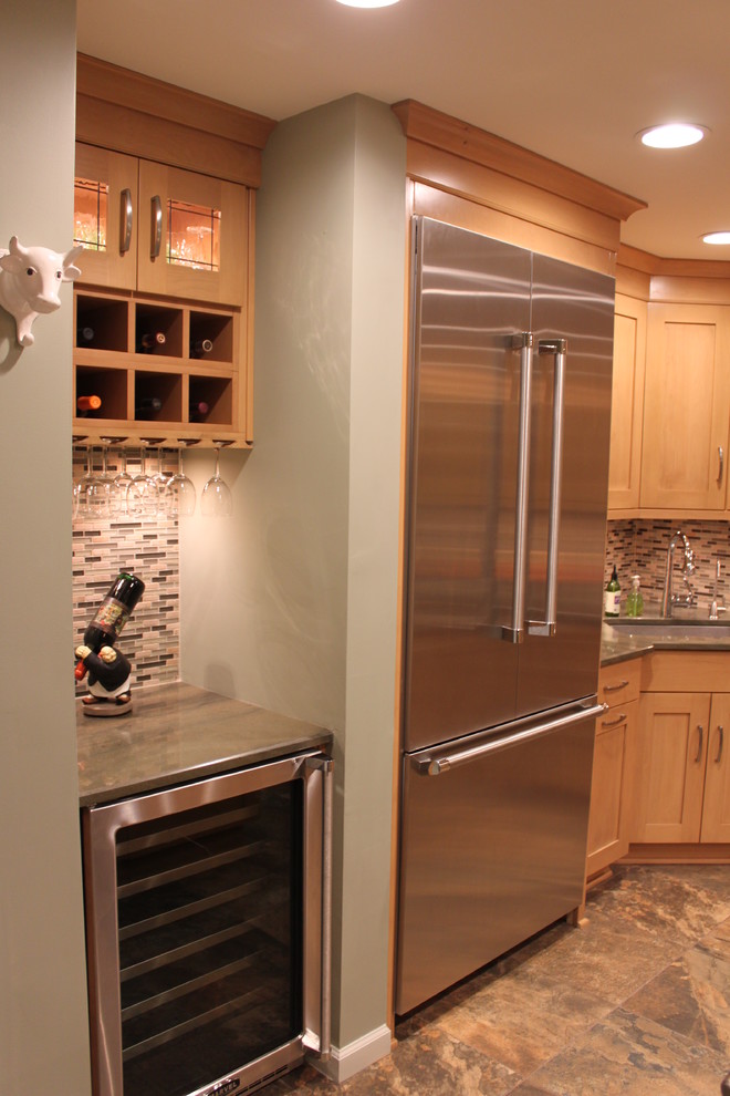 Mid-sized transitional galley porcelain tile eat-in kitchen photo in New York with an undermount sink, shaker cabinets, light wood cabinets, granite countertops, multicolored backsplash, stainless steel appliances, metallic walls and an island