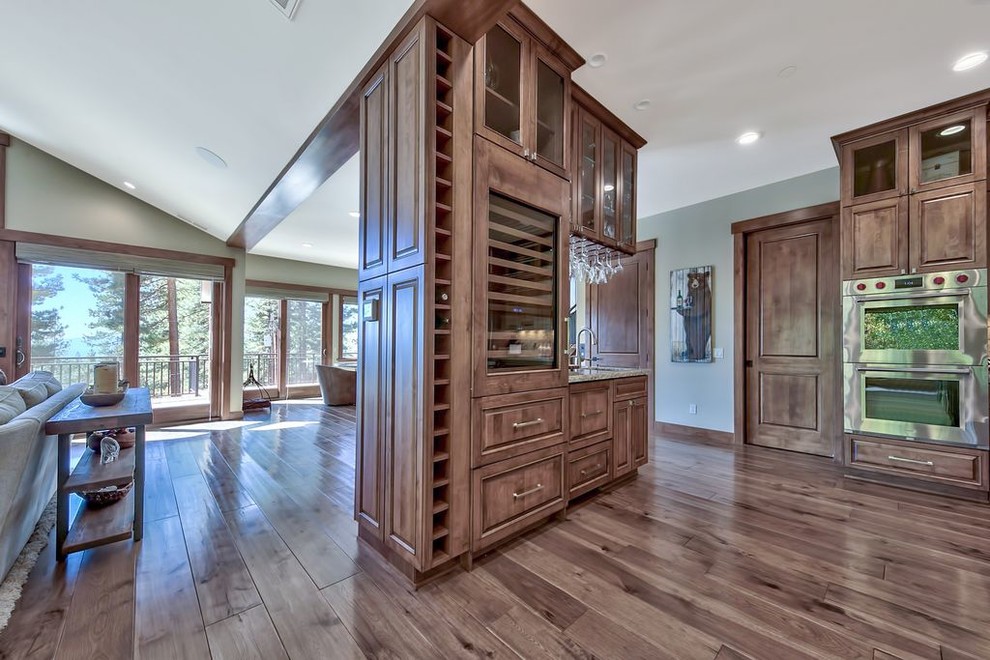 This is an example of a small transitional wine cellar in Other with medium hardwood floors, display racks and multi-coloured floor.