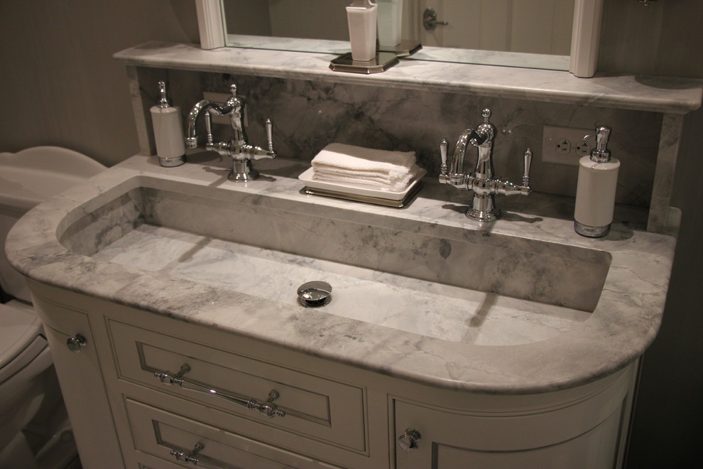 Photo of a mid-sized traditional master bathroom in Other with recessed-panel cabinets, white cabinets, a drop-in tub, a shower/bathtub combo, gray tile, grey walls, marble floors, an integrated sink and marble benchtops.