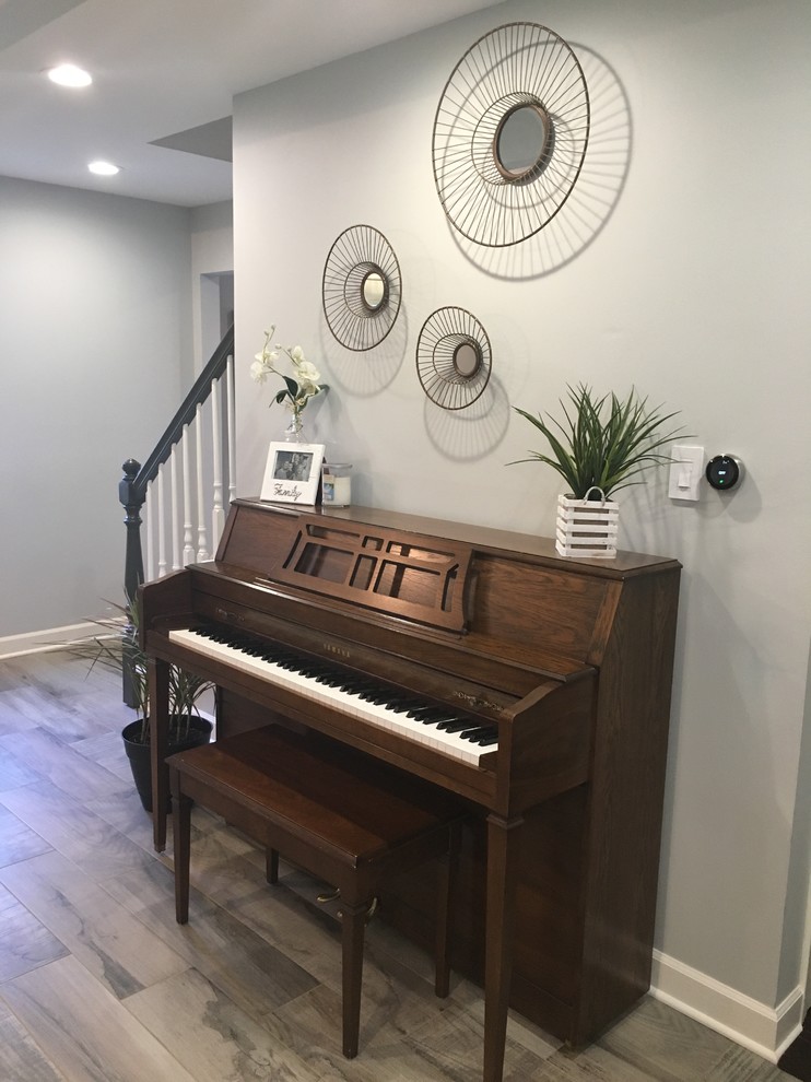 Example of a large transitional gray floor home design design in Chicago with gray walls, a standard fireplace and a wood fireplace surround