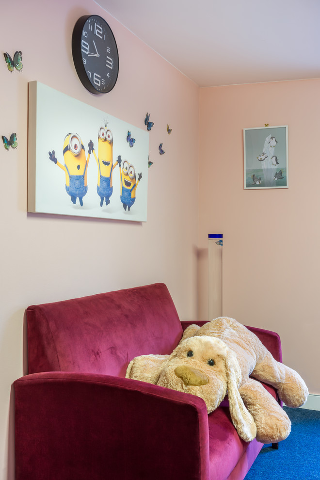 This is an example of a small contemporary family room in Dublin with pink walls, carpet, no fireplace, a wall-mounted tv and blue floor.
