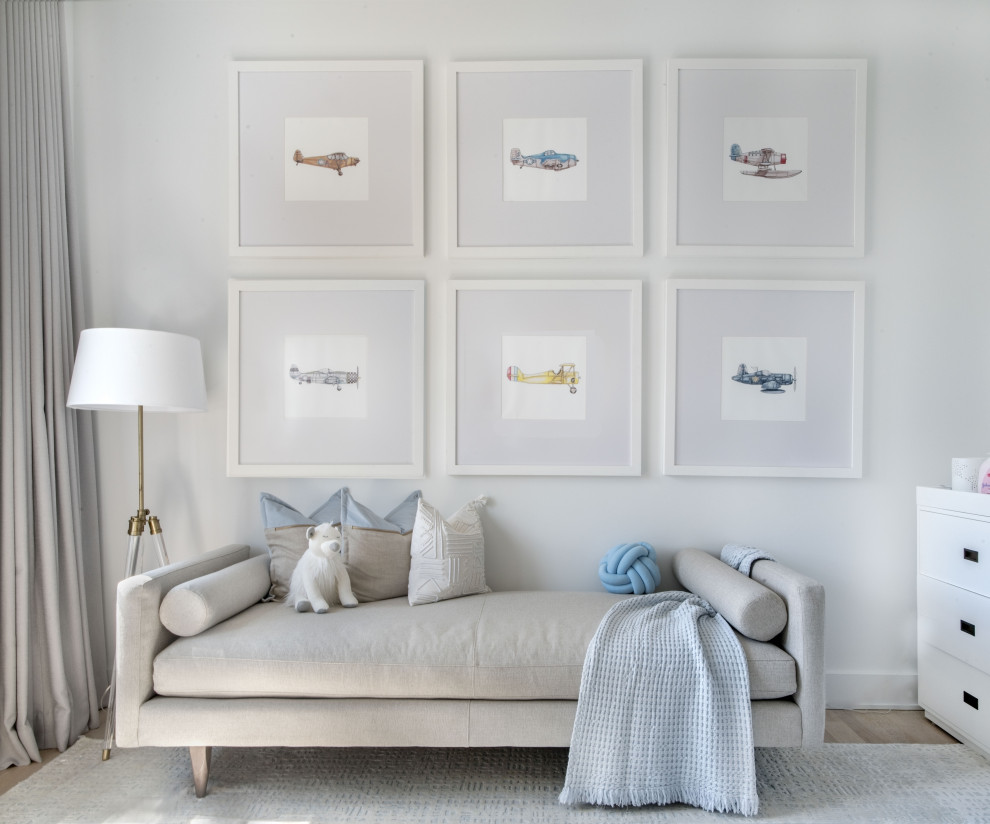 Inspiration for a coastal gender-neutral light wood floor nursery remodel in New York with white walls