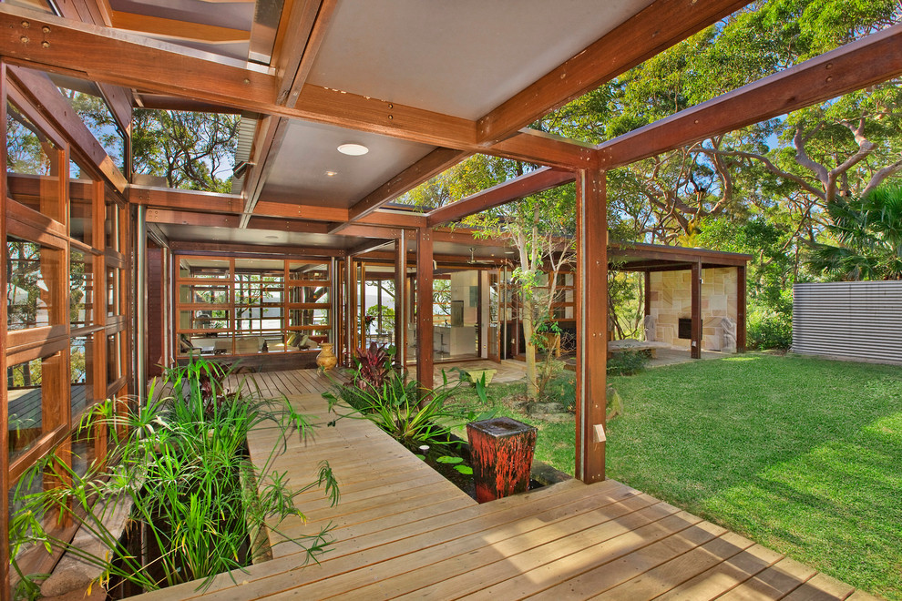 Design ideas for a large contemporary deck in Sydney with a water feature and an awning.