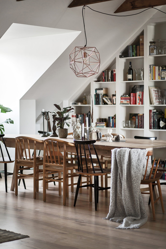 Inspiration for a mid-sized scandinavian dining room in Stockholm with white walls, light hardwood floors and no fireplace.