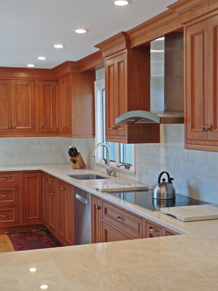 Example of a large transitional l-shaped light wood floor open concept kitchen design with a single-bowl sink, beaded inset cabinets, medium tone wood cabinets, quartzite countertops, white backsplash, ceramic backsplash, stainless steel appliances and no island