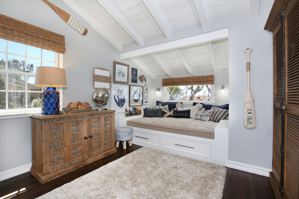 This is an example of a beach style bedroom in Orange County with grey walls, dark hardwood floors and no fireplace.
