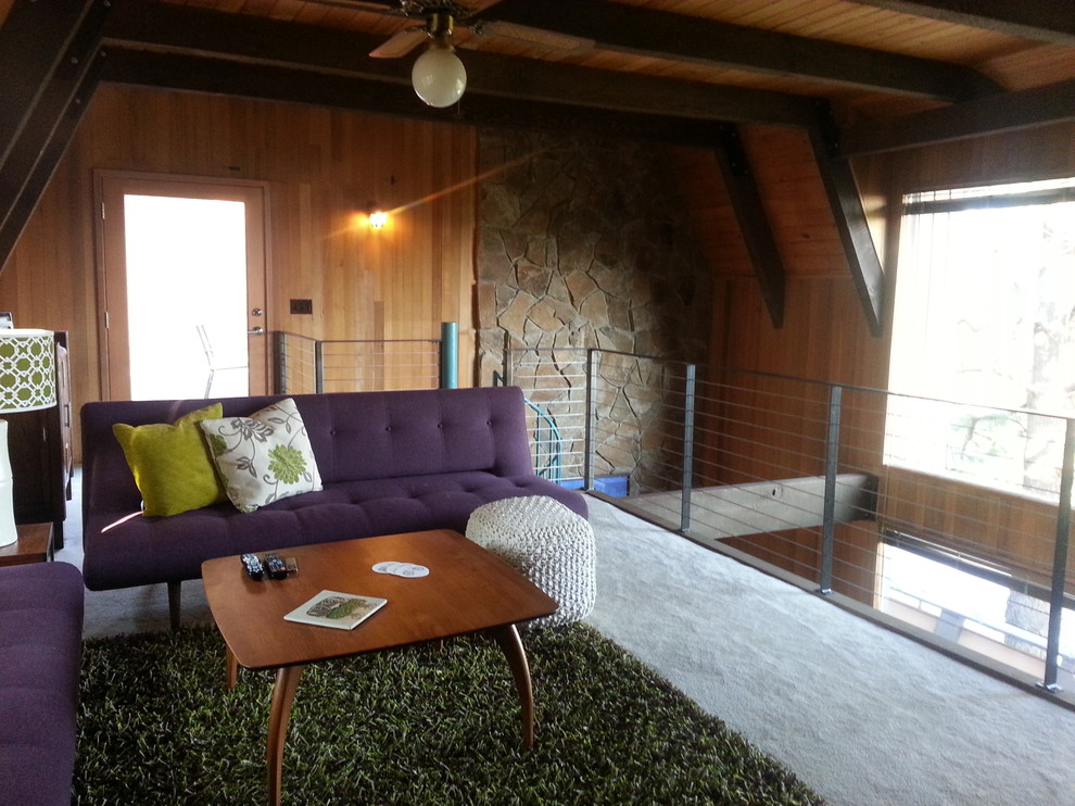 Photo of a small midcentury loft-style family room in Other with carpet, a standard fireplace and a stone fireplace surround.