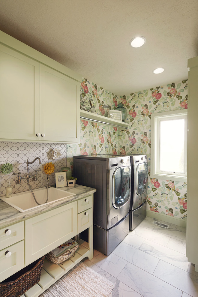 Example of a mid-sized mountain style galley white floor dedicated laundry room design with a single-bowl sink, shaker cabinets, beige cabinets, green walls, a side-by-side washer/dryer and gray countertops